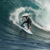 Person surfing on a large wave in the ocean